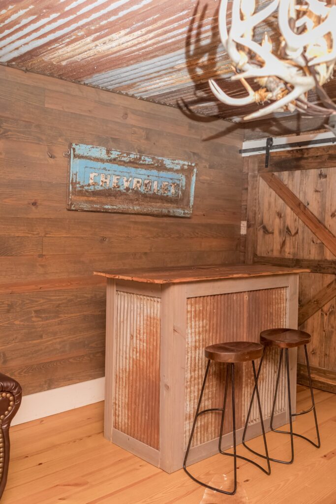 Rustic bar with two bar stools in groomsmens' room